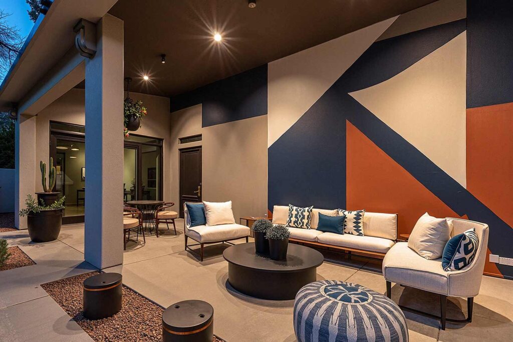 Contemporary Patio with Mural of Navy and Terracotta Geometric Shapes, Phoenix, Arizona, Desert lifestyle, Desert environment, Functional Terms:, Entertainment space, Gathering spot, Outdoor retreat, Living space, Patio color ideas, Phoenix outdoor living, Desert patio design, Outdoor paint colors, Patio transformation, Secondary Keywords: , Color combinations, Desert Modern, Mediterranean Oasis, Desert Sunset, Paint Techniques:, Color blocking, Ceiling painting, Painted rug designs, Mural designs, Zoning with color, Specific Areas:, Dining zone, Living zone, Accent zone, Conversation area
