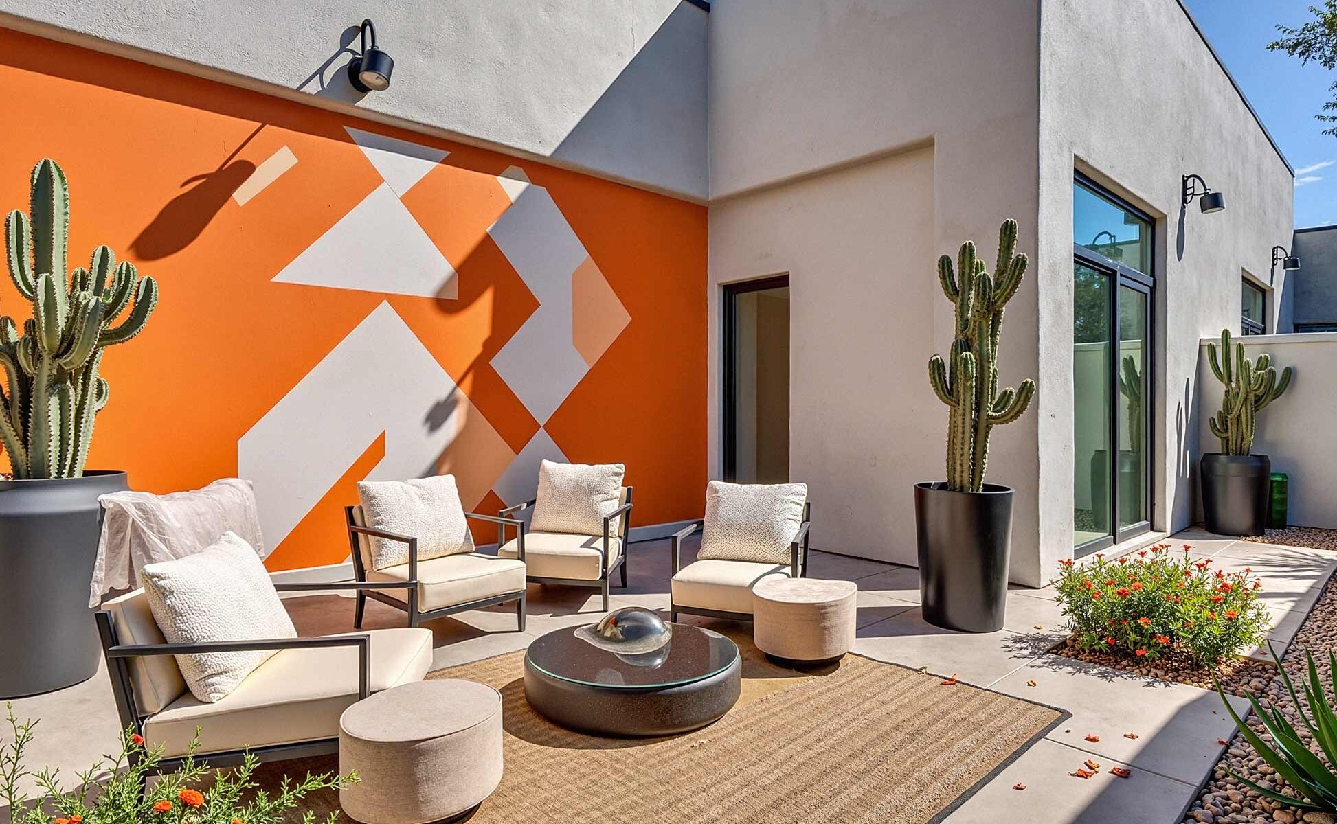 Contemporary Patio with Striking Orange and White Chevron Mural, Phoenix, Arizona, Desert lifestyle, Desert environment, Functional Terms:, Entertainment space, Gathering spot, Outdoor retreat, Living space, Patio color ideas, Phoenix outdoor living, Desert patio design, Outdoor paint colors, Patio transformation, Secondary Keywords: , Color combinations, Desert Modern, Mediterranean Oasis, Desert Sunset, Paint Techniques:, Color blocking, Ceiling painting, Painted rug designs, Mural designs, Zoning with color, Specific Areas:, Dining zone, Living zone, Accent zone, Conversation area
