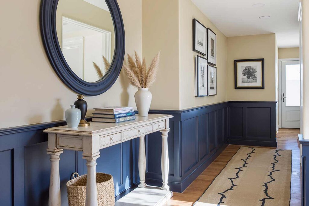 Hallway with Naval Wainscoting with Malabar Upper Walls and Oak Flooring, Hallway with Naval wainscoting, Malabar upper walls, natural oak floors, and coastal décor in a Scottsdale Colonial Revival home, hallway painting ideas, hallway paint colors, hallway color schemes, hallway paint combinations, narrow hallway paint ideas, small hallway paint colors, corridor paint designs, entryway color schemes, passageway painting inspiration, foyer paint ideas, hallway color inspiration, corridor decorating concepts, entrance paint solutions, hallway makeover ideas, passage color ideas, vestibule painting concepts, color scheme, paint design, color combination, paint treatment, wall treatment, color palette, paint finish, wall colors, paint selection hallway, color choice, color pairings, color duos, paint matches, color coordination, color harmony, paint partnerships, color marriages, tone combinations, shade pairings, chromatic duets, connecting area, passage space colors, intermediate zone colors, linking space colors, connecting corridor colors, transition zone colors, thoroughfare colors, connecting pathway colors, interim space colors, passage area colors, refined, elegant, polished, upscale, distinguished painter, cultivated, tasteful, luxurious, elevated, high-end painting