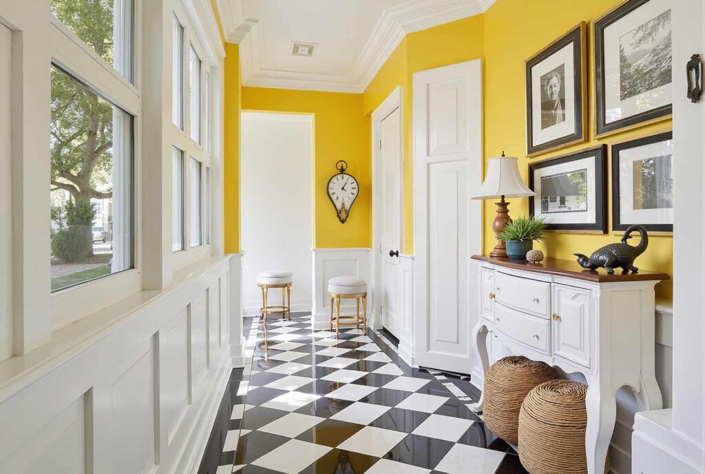 Hallway with Yellow Accent Wall and White Surroundings and Checkerboard Flooring, Colonial Revival hallway with Bosc Pear yellow accent wall, Pure White surroundings, checkerboard tiles, and afternoon sunlight in a Scottsdale home, hallway painting ideas, hallway paint colors, hallway color schemes, hallway paint combinations, narrow hallway paint ideas, small hallway paint colors, corridor paint designs, entryway color schemes, passageway painting inspiration, foyer paint ideas, hallway color inspiration, corridor decorating concepts, entrance paint solutions, hallway makeover ideas, passage color ideas, vestibule painting concepts, color scheme, paint design, color combination, paint treatment, wall treatment, color palette, paint finish, wall colors, paint selection hallway, color choice, color pairings, color duos, paint matches, color coordination, color harmony, paint partnerships, color marriages, tone combinations, shade pairings, chromatic duets, connecting area, passage space colors, intermediate zone colors, linking space colors, connecting corridor colors, transition zone colors, thoroughfare colors, connecting pathway colors, interim space colors, passage area colors, refined, elegant, polished, upscale, distinguished painter, cultivated, tasteful, luxurious, elevated, high-end painting