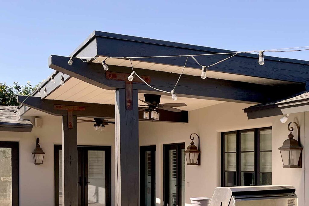 Light beige walls with Deep Bronze eaves and fascia, painting stained wood, painted wood patio, stained wood makeover, refinished wood eaves, wood stain transformation, painted over stain, stained wood update, exterior wood painting, outdoor wood refinishing, patio wood paint, exterior wood transformation, painted patio features, outdoor wood makeover, patio eaves painting, fascia transformation, painted wood trim, desert patio makeover, southwestern patio update, outdoor wood color ideas