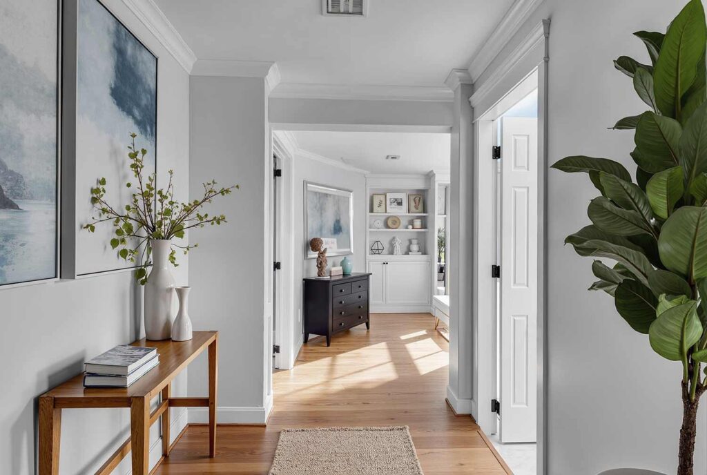 hallway with pale blue walls crisp white trim and a warm oak floor, Soft Serenity hallway with pale blue walls, white trim, warm oak floors, Mid-Century Modern décor, and dramatic sunlight casting shadows, hallway painting ideas, hallway paint colors, hallway color schemes, hallway paint combinations, narrow hallway paint ideas, small hallway paint colors, corridor paint designs, entryway color schemes, passageway painting inspiration, foyer paint ideas, hallway color inspiration, corridor decorating concepts, entrance paint solutions, hallway makeover ideas, passage color ideas, vestibule painting concepts, color scheme, paint design, color combination, paint treatment, wall treatment, color palette, paint finish, wall colors, paint selection hallway, color choice, color pairings, color duos, paint matches, color coordination, color harmony, paint partnerships, color marriages, tone combinations, shade pairings, chromatic duets, connecting area, passage space colors, intermediate zone colors, linking space colors, connecting corridor colors, transition zone colors, thoroughfare colors, connecting pathway colors, interim space colors, passage area colors, refined, elegant, polished, upscale, distinguished painter, cultivated, tasteful, luxurious, elevated, high-end painting