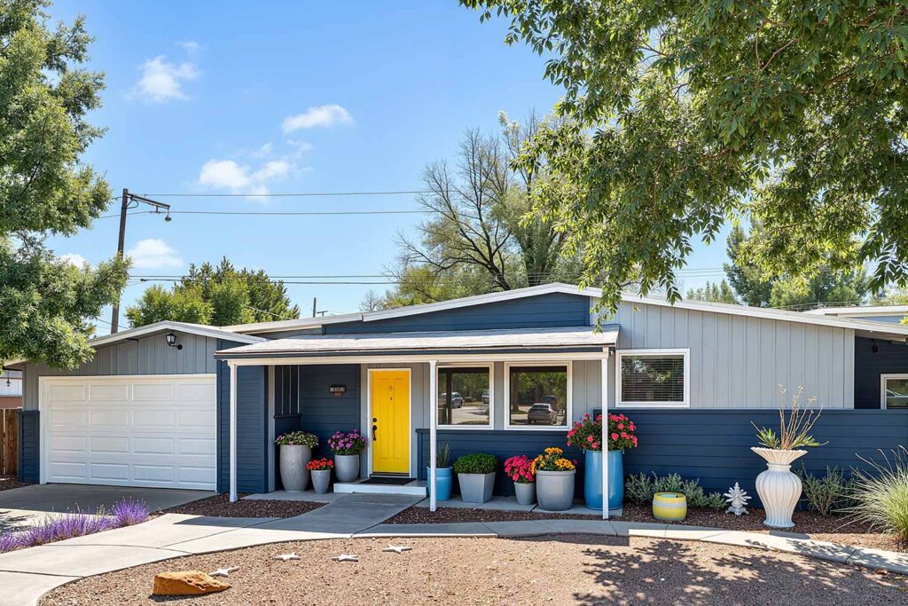 Mid-Century Ranch with Gray Walls Charcoal Blue Accent White Trim Yellow Door, ranch house color scheme, ranch house colors, Exterior color ideas, House painting inspiration, Two-tone color scheme, Ranch architecture, ranch style, ranch home, ranch silhouette, Color combination, color palette, color pairing, color expression, Exterior Facade, outdoor, outside surface, exterior walls, Modern, Contemporary, current, updated, fresh, Transformation, Makeover, reimagining, updating, refreshing,