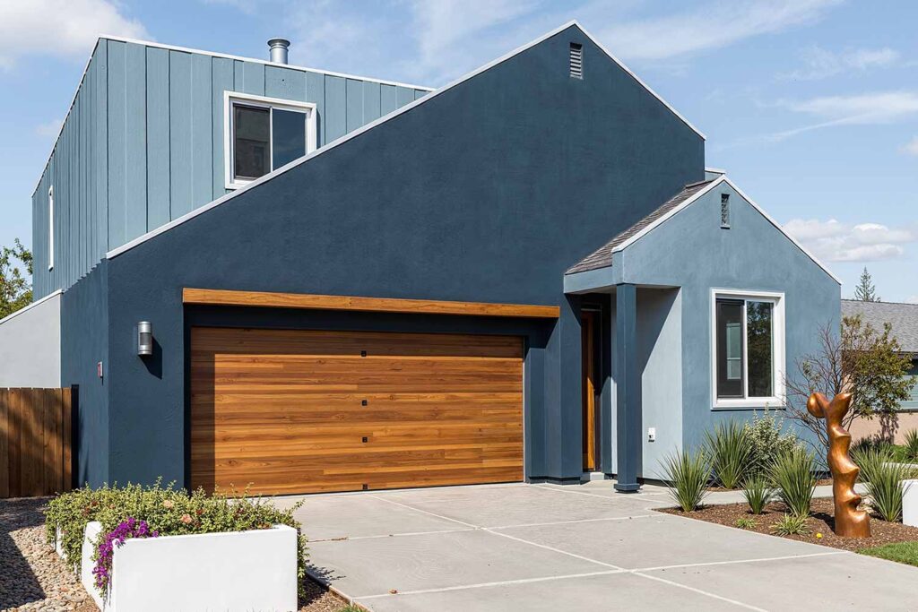 Modern House with Slate Blue Walls Lighter Blue Accent Wall White Trim and Wood Doors, exterior house colors, home exterior painting, exterior color ideas, exterior home painting, tone-on-tone color schemes, curb appeal, architectural style, accent walls, body color, accent shade, trim color, front door color, tone-on-tone exterior, architectural details, color family, exterior transformation, layered colors, exterior color stories, exterior color palettes, exterior color combinations, home color schemes, exterior painting project, exterior painting transformation, exterior color application, layered shades, different shades within the same color family, subtle shifts, tonal shifts, color progression