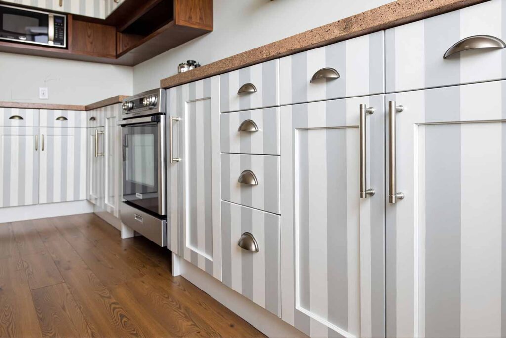 Beautiful White Cabinets With A Vertical Gray and White Striped Pattern, painting kitchen cabinets, cabinet painting, cabinet paint transformation, refreshing cabinets, updating kitchen cabinets, cabinet color application, painting contractor, professional painter, cabinet painting expert, painting professional, cabinet refresh concepts, cabinet update inspiration, cabinet renovation ideas, cabinet redesign strategies, creative kitchen cabinets