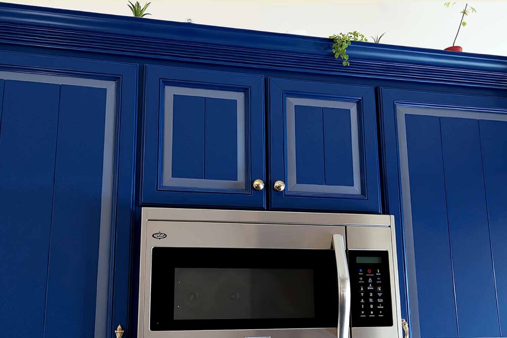 Raised Panel Kitchen Cabinets Painted In 2 Colors of Blue, Cabinet accent painting, Specialty cabinet finishes, Bold cabinet graphics, Cabinet mural designs, Artistic cabinet treatments, Contemporary cabinet art, Cabinet stencil painting, Color-blocked cabinets, Linear cabinet designs, Cabinet makeover ideas, Kitchen cabinet striping, Cabinet feature painting, Unique cabinet finishes, Statement cabinet art, Transformative cabinet painting, Painted kitchen accents, Cabinet surface design, Decorative kitchen makeovers, Modern kitchen pattern painting