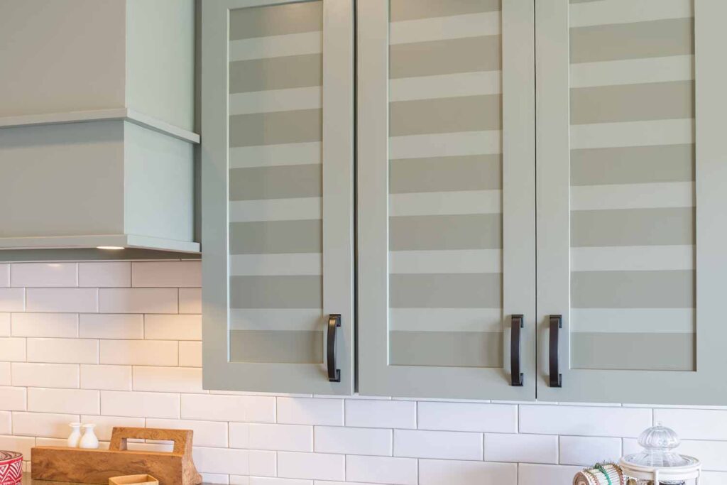 Sage Green Cabinets With Painted Horizontal Stripes, Cabinet accent painting, Specialty cabinet finishes, Bold cabinet graphics, Cabinet mural designs, Artistic cabinet treatments, Contemporary cabinet art, Cabinet stencil painting, Color-blocked cabinets, Linear cabinet designs, Cabinet makeover ideas, Kitchen cabinet striping, Cabinet feature painting, Unique cabinet finishes, Statement cabinet art, Transformative cabinet painting, Painted kitchen accents, Cabinet surface design, Decorative kitchen makeovers, Modern kitchen pattern painting