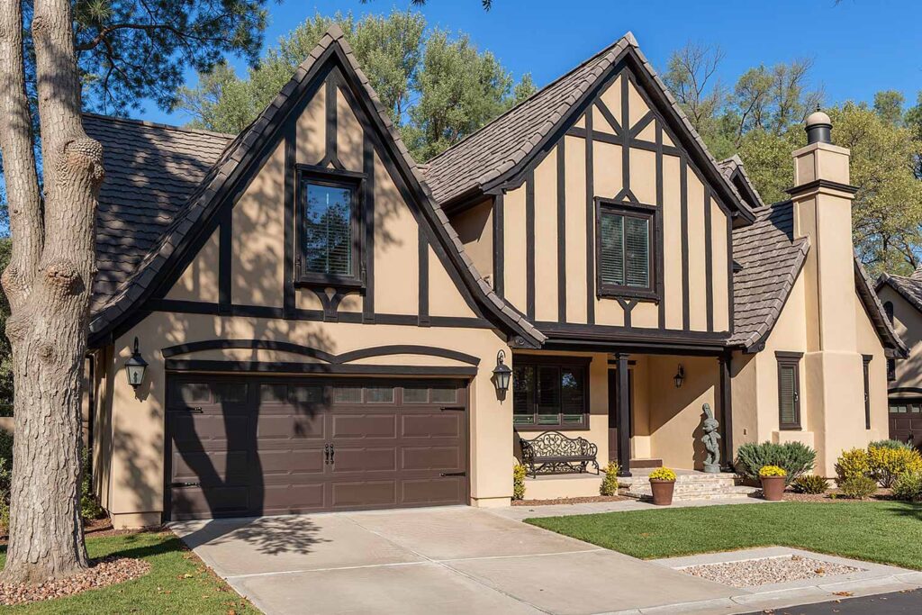 Arcadia Tudor Revival House with Beige Stucco Walls Dark Brown Gable Timber Detailing, decorating gable features, triangular section finishing, roof end decoration, gable area coating, gable color enhancement, painting dormer, dormer painting, decorative truss, gable wall, gable colors, house painters Phoenix