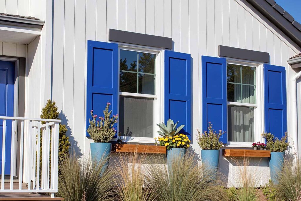 White Scottsdale Farmhouse with Cobalt Blue Shutters and Matte Black Trim, shutter color guide, window trim colors, shutter coating types, shutter color matching, shutter design colors, shutter painter, painting contractor Phoenix