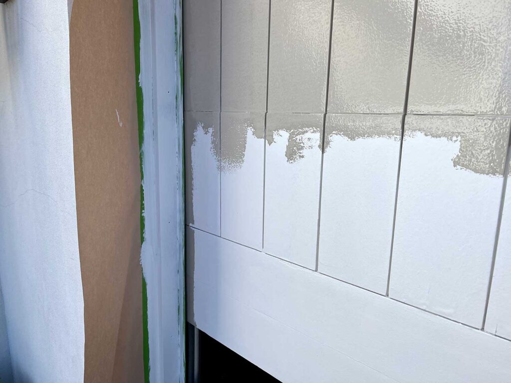 Prepping for paint, a partially painted garage door