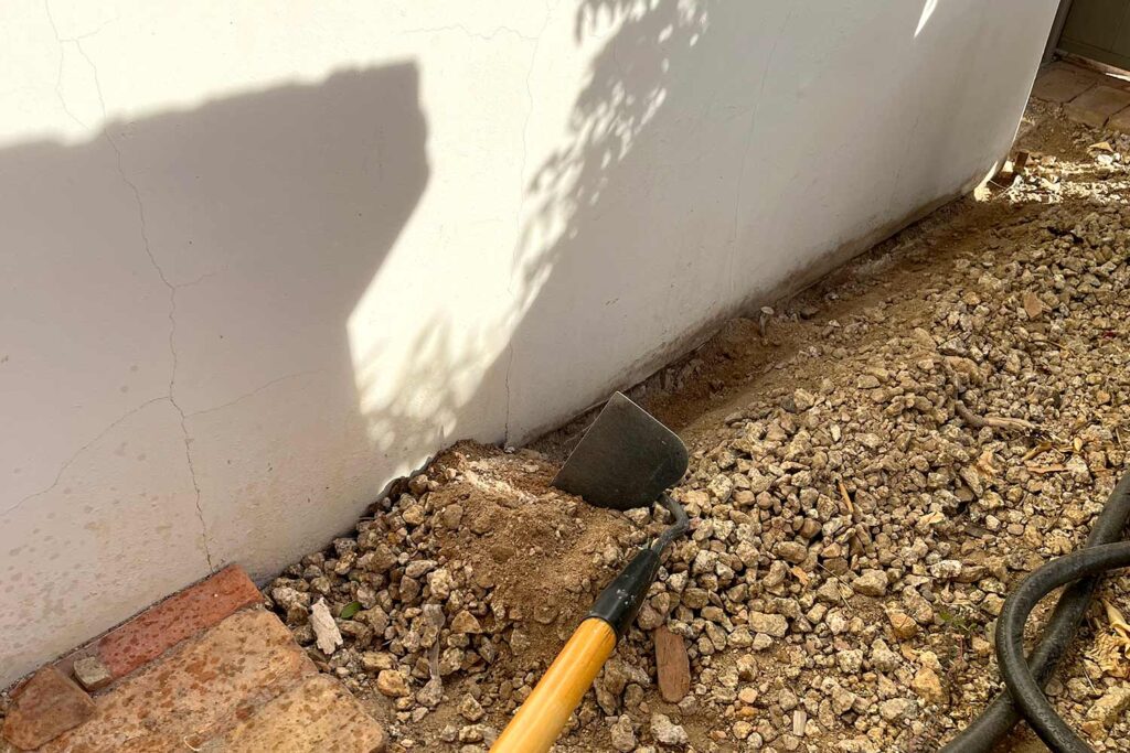 Trench for painting under the soil line of a house, painting the exterior of a house