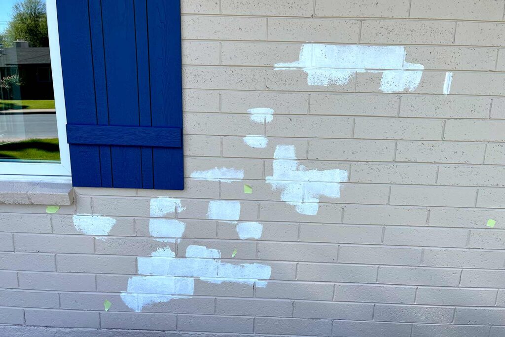 spot priming on a tan or beige Phoenix Arcadia ranch house with blue shutters and blue trim, masonry block house, Any places where paint has peeled or there have been minor repairs need to be spot-primed. Spot priming may be necessary to prep for small blemishes, , exterior paint problems, exterior paint issues, exterior paint failure, paint defects on house exterior, paint peeling outside, paint damage on house, house paint problems,