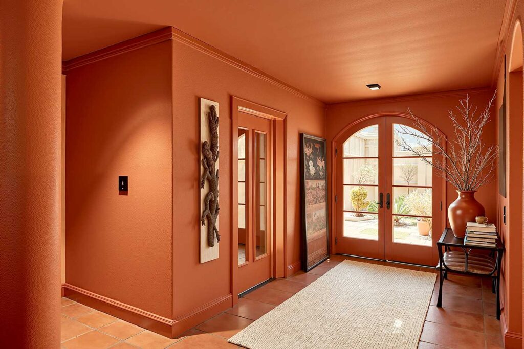 Earthy Burnt Sienna Entryway with Matte Terracotta Tile Floor-2, tonal paint technique, cohesive color interior, all-surface color painting, wraparound color design, floor-to-ceiling color scheme, saturated room painting, seamless color interior, whole-room color palette