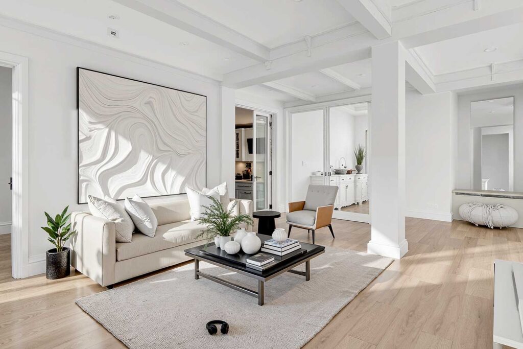 Luminous Warm White Color Drenched Living Room with Bleached Oak Floors, color drenching interior paint, immersive interior color, all-over interior paint, enveloping color scheme, single-hue room design, full-room color saturation, unified color interior, total surface paint treatment