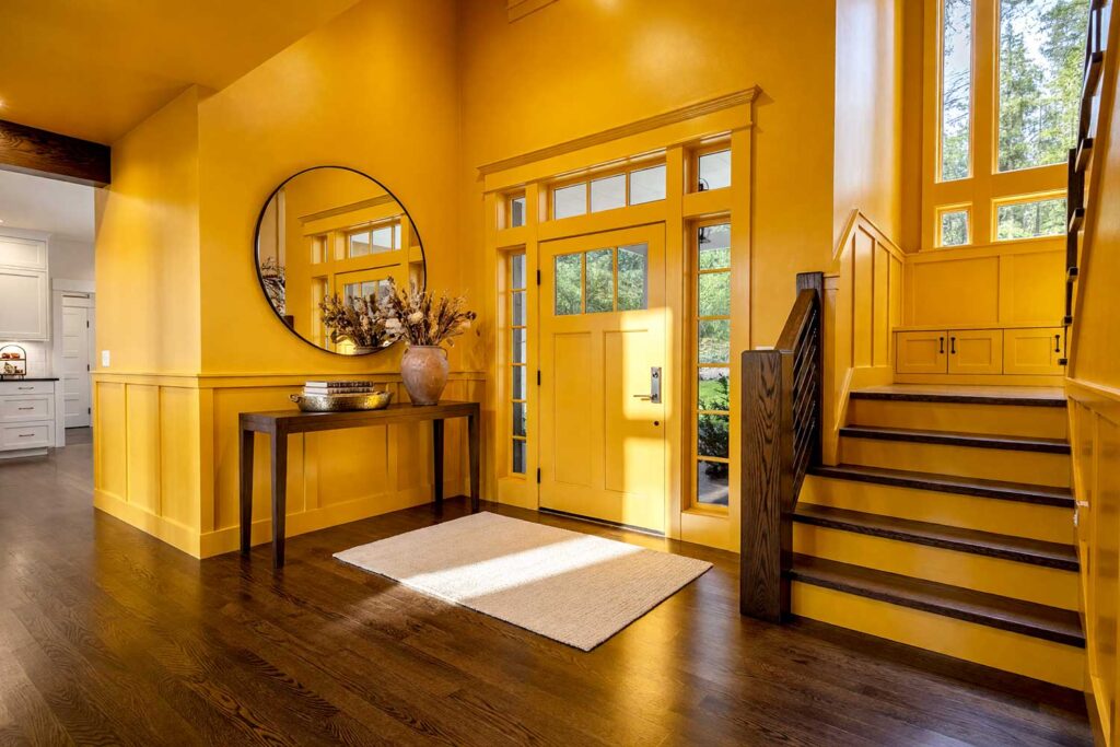 Yellow Ochre Entryway with Dark Espresso Wood Floors-1, color drenching interior paint, immersive interior color, all-over interior paint, enveloping color scheme, single-hue room design, full-room color saturation, unified color interior, total surface paint treatment