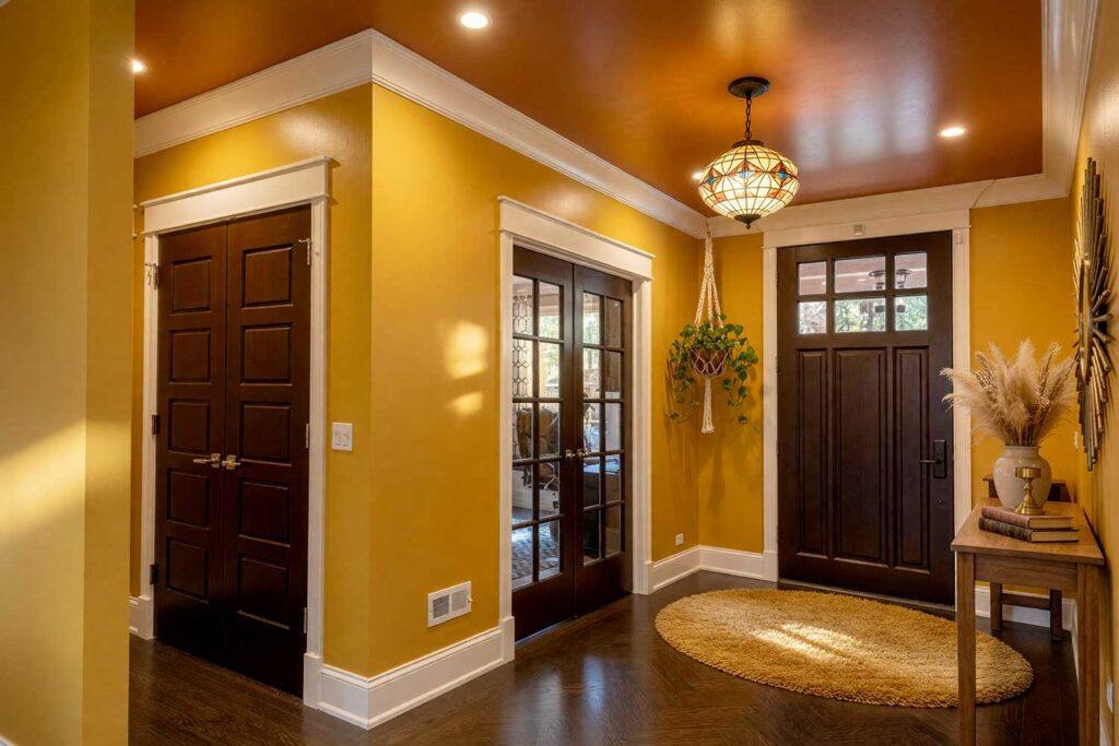 1970s Mustard Sunrise Entry Foyer with Mustard Yellow Walls and Warm Terracotta Ceiling-1, warm 1970s entry foyer with mustard yellow walls warm terracotta ceiling espresso brown door ivory cream trim and retro décor featuring sunburst mirror macramé plant hanger and Tiffany light dramatic sunlight in Scottsdale, classic retro colors, nostalgic home colors, throwback paint palette, retro-modern color palette, old-school color palette, nostalgic color scheme, vintage room colors, retro color revival, classic color comeback, period paint palette, retro paint palette