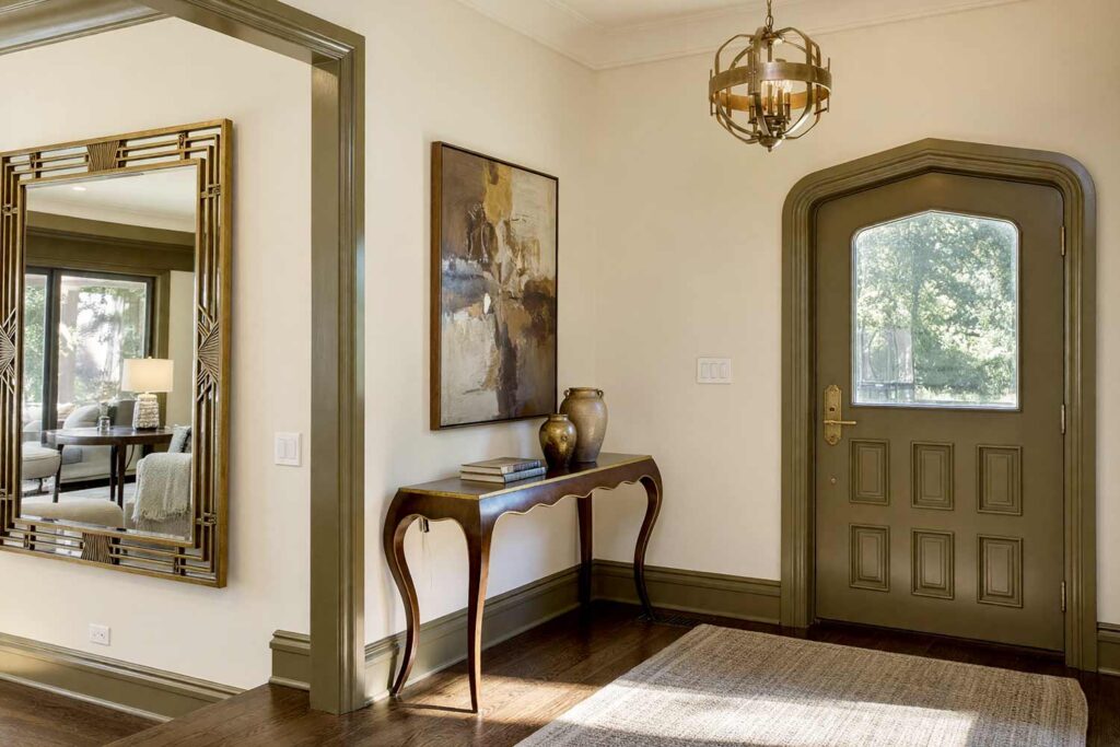 Art Deco Formal Entryway with Pale Wheat Walls and Olive Bronze Trim-1, art deco formal entryway with pale wheat walls olive bronze trim aged gold hardware and dark oak floors in a Scottsdale neighborhood with dramatic sunlight, art deco formal entryway with pale wheat walls olive bronze trim aged gold hardware and dark oak floors in a Scottsdale neighborhood freshly painted elegant entryway features Art Deco details and bold sunlight, colored baseboards, painted baseboards, door trim color ideas, crown molding colors, interior trim color ideas, trim color combinations, interior trim paint colors, non-white trim colors