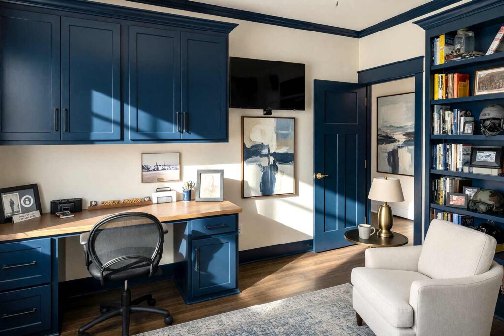 Coastal Home Library with Creamy Linen Walls and Deep Navy Trim-4, coastal home library creamy linen walls deep navy trim aged oak flooring Scottsdale neighborhood dramatic sunlight, coastal home library creamy linen walls deep navy trim aged oak flooring Scottsdale neighborhood freshly painted inviting library with bold contrasting trim and dramatic sunlight, colored baseboards, painted baseboards, door trim color ideas, crown molding colors, interior trim color ideas, trim color combinations, interior trim paint colors, non-white trim colors
