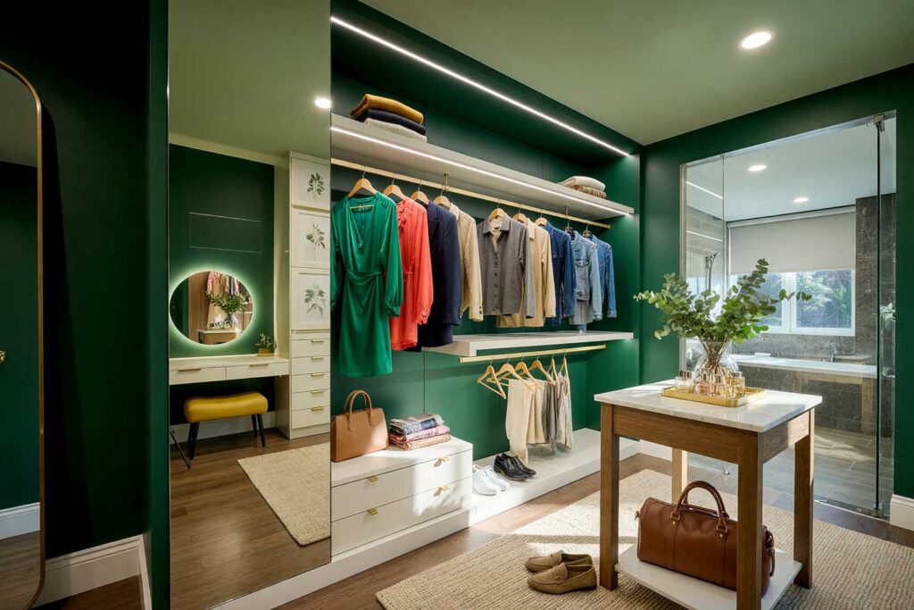 Walk-in Closet with Forest Green Walls Soft Sage Ceiling and Ivory Cabinetry-1, luxurious walk-in closet with forest green walls soft sage ceiling warm ivory cabinetry and walnut floors Scottsdale neighborhood luxurious walk-in closet with forest green walls soft sage ceiling warm ivory cabinetry and walnut floors boutique-inspired design in a Scottsdale neighborhood sunlight casting dramatic shadows, walk-in closet paint ideas, closet color ideas, closet painting inspiration, walk-in closet color schemes, walk-in closet paint colors, walk-in wardrobe paint ideas, walk-in closet wall colors, walk-in wardrobe color schemes, dressing room color ideas, dressing room color schemes, dressing room wall colors