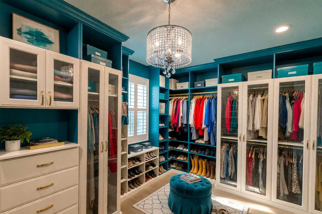 Walk-in Closet with Peacock Teal Walls Aqua Ceiling, and Ivory Cabinetry-3, vibrant walk-in closet with peacock teal walls soft aqua mist ceiling warm antique ivory cabinetry light oak flooring Scottsdale neighborhood vibrant walk-in closet with peacock teal walls soft aqua mist ceiling warm antique ivory cabinetry light oak flooring boutique-inspired design in a Scottsdale neighborhood sunlight casting dramatic shadows, walk-in closet paint ideas, closet color ideas, closet painting inspiration, walk-in closet color schemes, walk-in closet paint colors, walk-in wardrobe paint ideas, walk-in closet wall colors, walk-in wardrobe color schemes, dressing room color ideas, dressing room color schemes, dressing room wall colors