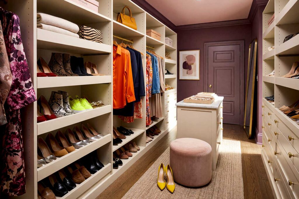 Walk-in Closet with Plum Walls Blush Pink Ceiling and Warm Cream Cabinetry-2, luxurious walk-in closet with deep dusty plum walls pale blush pink ceiling warm cream cabinetry and walnut floors Scottsdale neighborhood luxurious walk-in closet with deep dusty plum walls pale blush pink ceiling warm cream cabinetry walnut floors boutique-inspired design in a Scottsdale neighborhood sunlight casting dramatic shadows, walk-in closet paint ideas, closet color ideas, closet painting inspiration, walk-in closet color schemes, walk-in closet paint colors, walk-in wardrobe paint ideas, walk-in closet wall colors, walk-in wardrobe color schemes, dressing room color ideas, dressing room color schemes, dressing room wall colors
