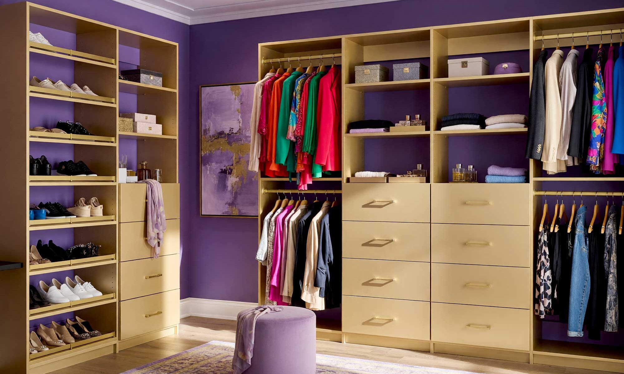 Walk-in Closet with Rich Amethyst Walls and Champagne Gold Cabinetry-2-FEATURE, vibrant walk-in closet with amethyst walls pale silver-lavender ceiling champagne gold cabinetry and warm hardwood floors Scottsdale neighborhood vibrant walk-in closet with amethyst walls pale silver-lavender ceiling champagne gold cabinetry and warm hardwood floors boutique dressing room feel in a Scottsdale neighborhood sunlight casting dramatic shadows luxurious and fresh design, walk-in closet paint ideas, closet color ideas, closet painting inspiration, walk-in closet color schemes, walk-in closet paint colors, walk-in wardrobe paint ideas, walk-in closet wall colors, walk-in wardrobe color schemes, dressing room color ideas, dressing room color schemes, dressing room wall colors