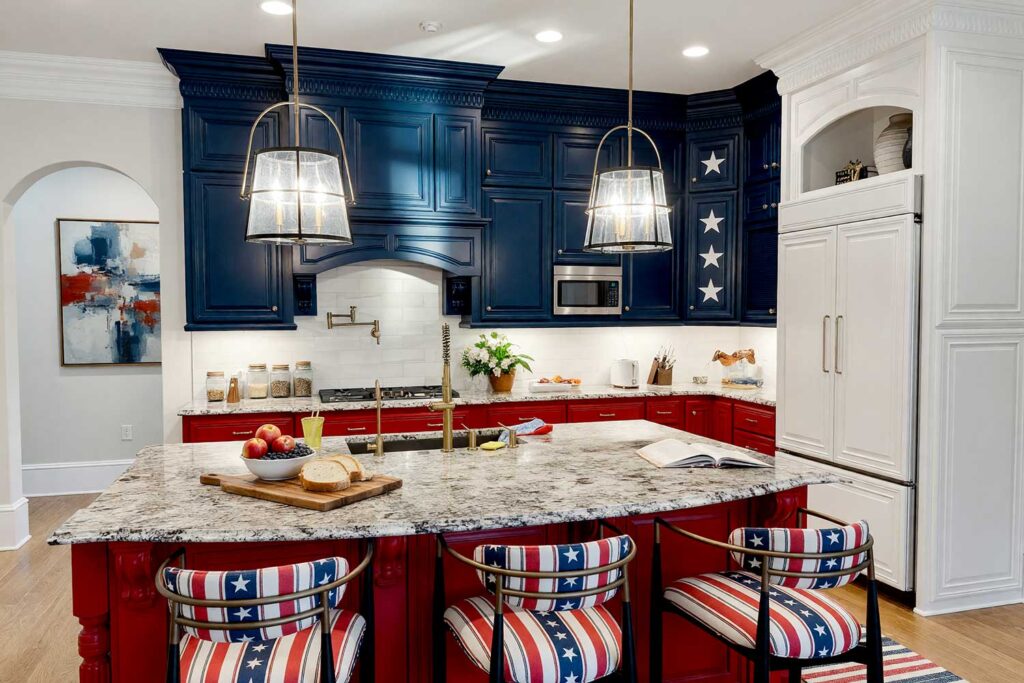 Kitchen with Patriot Red and Classic Navy-Blue Two-Toned Cabinets with Star Feature-14, a bold and celebratory scottsdale neighborhood kitchen with shaker-style cabinets painted in patriot red and classic navy blue. a single cabinet door features white stars on navy blue, creating a standout detail. bright white walls and trim complement light oak flooring. décor includes a wooden cutting board, ceramic fruit bowl, potted plants, and patriotic artwork. dramatic sunlight and moody lighting enhance the fresh and unforgettable atmosphere, two-tone kitchen cabinets, dual-tone kitchen cabinets, two-color kitchen cabinets, contrasting kitchen cabinets, multi-colored kitchen cabinets