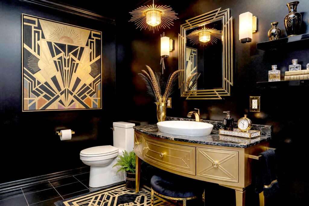 Art Deco Glamour Powder Room with Onyx Black Walls Gold Cabinet and Charcoal Trim-1, art deco glamour powder room onyx black walls honeyed gold cabinet charcoal trim sunburst mirror. A luxurious Art Deco-inspired powder room in a Scottsdale neighborhood featuring dramatic onyx black walls, a honeyed gold geometric vanity with a black marble countertop, and a brass sunburst mirror. Dynamic lighting highlights the rich textures and bold colors, evoking the opulence of a 1920s Parisian cocktail lounge. powder room paint ideas, powder room paint colors, powder room color inspiration, half bath paint ideas, bathroom color ideas, powder room color ideas, small bathroom paint ideas, powder room color schemes, guest bathroom paint ideas