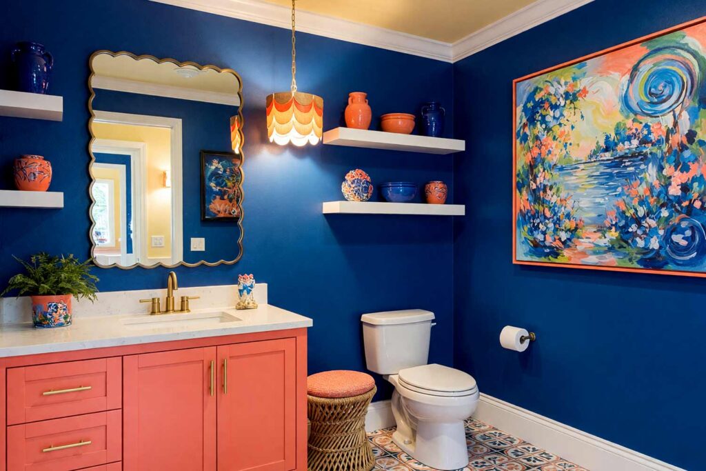 Mediterranean Powder Room with Deep Cobalt Blue Walls Coral Cabinet and Pale Yellow Ceiling-2, vibrant mediterranean revival powder room deep cobalt blue walls coral cabinet pale yellow ceiling vibrant artwork. A lively powder room in a Scottsdale neighborhood featuring deep cobalt blue walls paired with a playful coral vanity and pale yellow ceiling. The vibrant artwork, scalloped lighting, and curated decor create a cheerful Mediterranean vibe. Dynamic lighting highlights the rich colors and textures, making every visit feel like a getaway. powder room paint ideas, powder room paint colors, powder room color inspiration, half bath paint ideas, bathroom color ideas, powder room color ideas, small bathroom paint ideas, powder room color schemes, guest bathroom paint ideas