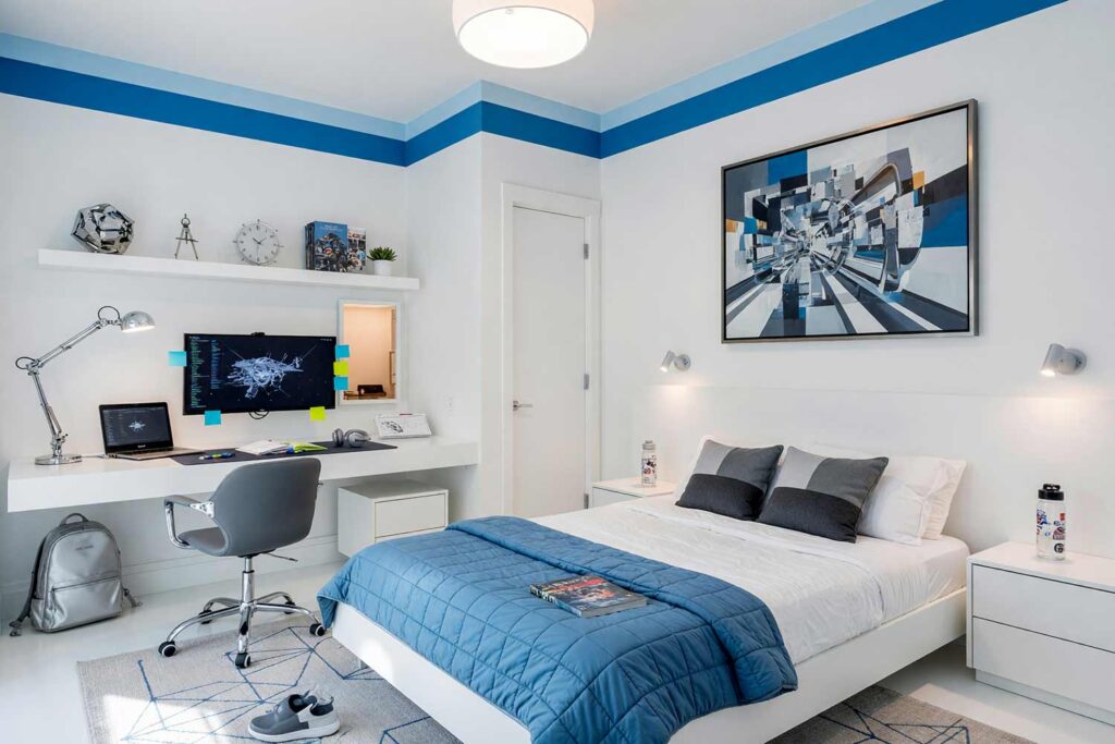 High-Tech Futuristic Pod Child’s Bedroom with Graphite and Blue Stripe-3, kid’s bedroom paint colors futuristic pod cool arctic white graphite ice blue white resin floor. An aspirational High-Tech Futuristic child's bedroom in a Scottsdale neighborhood featuring cool arctic white walls, a crisp painted border line in graphite and ice blue, and lustrous crisp white semi-gloss woodwork. This modern pod retreat combines an unmade, full-size composite platform bed with a streamlined floating desk hosting an active dual-screen computer setup, floating shelving, and a geometric sculpture. Seamless white resin flooring and dramatic directional daylight create a sleek, high-contrast sanctuary engineered for tomorrow's thinkers. kids bedroom paint ideas, child's bedroom color palette, kids room paint colors, toddler bedroom paint colors, kids bedroom colors