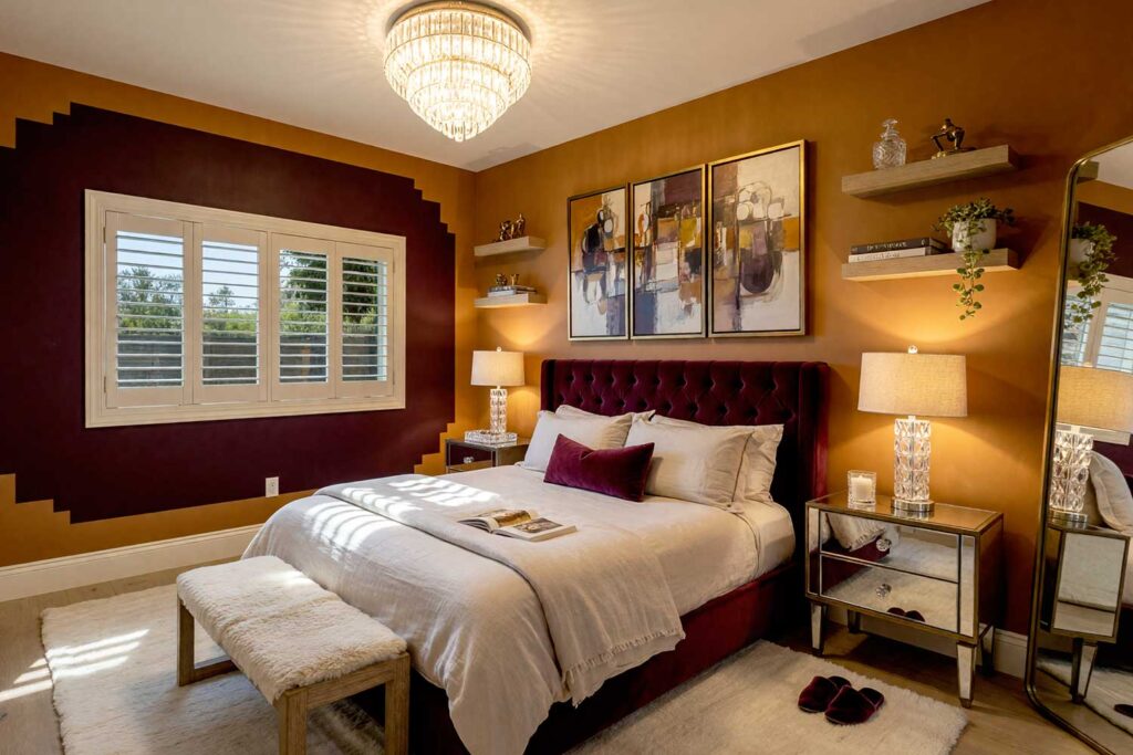 Hollywood Glam Bedroom with Pumpkin Walls Aubergine Window Apron-4, hollywood glam bedroom pumpkin walls aubergine painted wall graphics soft white ceiling bleached oak flooring. A lavish master bedroom in a Scottsdale neighborhood featuring bold pumpkin walls, a soft white ceiling, and a deep aubergine window apron painted wall graphic. Styled with an aubergine velvet bed with rumpled silk linens, mirrored nightstands, crystal table lamps, and bleached oak floors. High-contrast golden-hour light casts dramatic shadows throughout, evoking the timeless allure of golden-age Hollywood glamour. graphic wall, wall graphic design, painted wall art, accent wall graphics