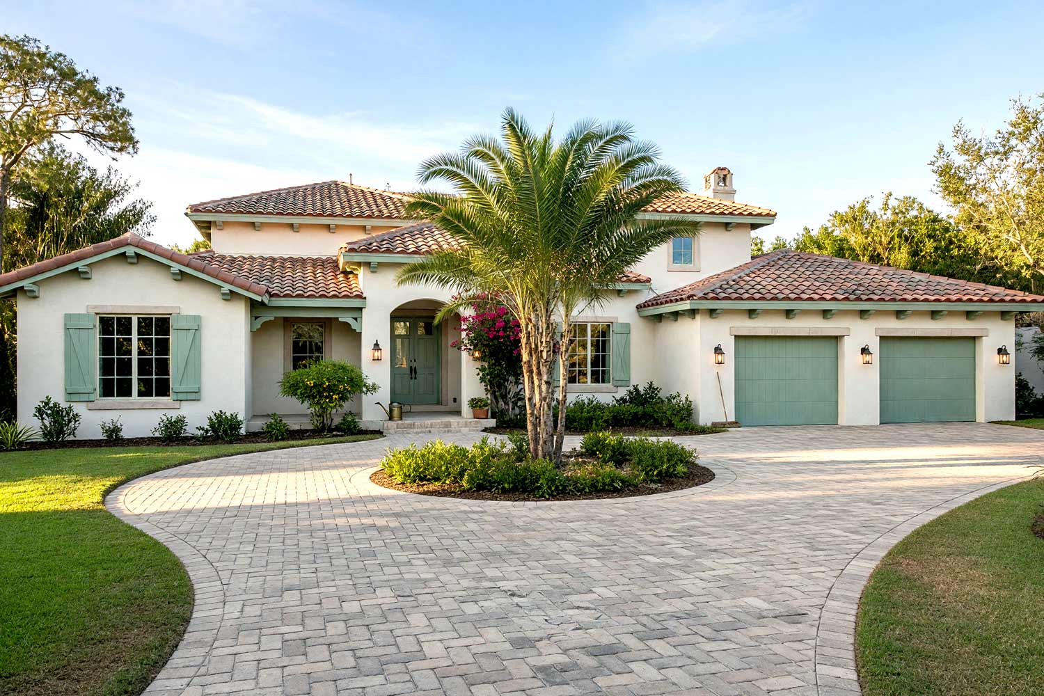 Mediterranean Home with Linen Stucco and Weathered Seafoam Trim-4, santa barbara modern mediterranean exterior paint colors soft linen stucco weathered seafoam trim peach terracotta roof paver motor court and turf front facade. A custom Scottsdale estate featuring mineral matte soft linen stucco, glossy weathered seafoam carriage doors, and peach terracotta tiles. Complete with a sweeping paver motor court, potted lemon verbena, and evening lantern illumination. santa barbara style paint colors, spanish hacienda exterior paint colors, mediterranean revival exterior colors, stucco house paint colors, terracotta roof house colors