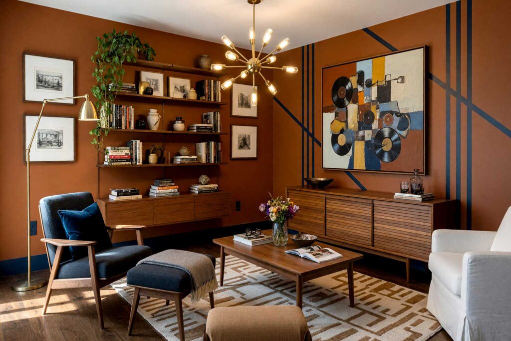 Mid-Century Modern Living Room with Burnt Sienna Walls Ink and Navy Pinstripes-1, mid-century modern living room burnt sienna walls ink navy painted wall graphics soft white ceiling walnut flooring. A tranquil lounge in a Scottsdale neighborhood featuring burnt sienna walls, a soft white ceiling, and an asymmetric ink navy pinstripe painted wall graphic. Detailed with a walnut-armed lounge chair, arched brass floor lamp, dense modular bookshelves, and rich dark walnut floors. High-contrast afternoon light creates bold shadows throughout, capturing the timeless elegance of authentic mid-century design. hand-painted wall designs, decorative wall painting