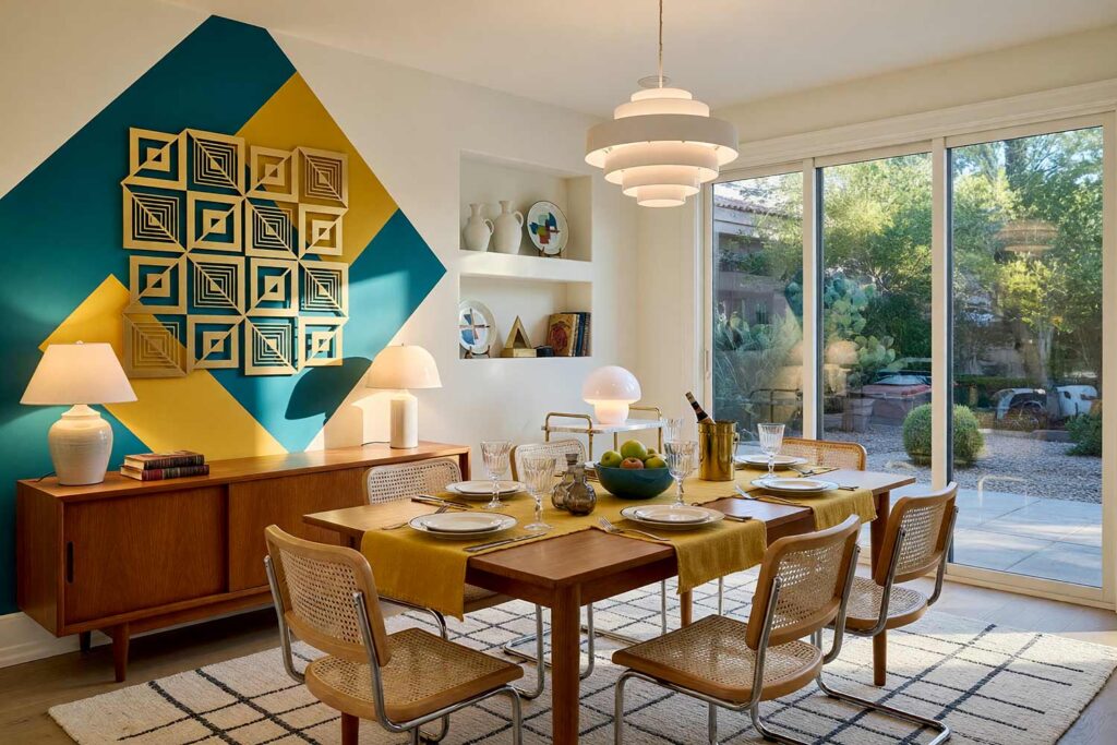 Dining Room with Alabaster Walls and Teal Accent and Wall Sculpture-1, graphic mid-century dining room alabaster walls peacock teal painted diamonds painting for wall sculptures pale bone trim light wood floor. An art-infused dining experience in a Scottsdale neighborhood featuring a gold nested-square metal sculpture backed by overlapping peacock teal and mustard yellow painted diamonds. Featuring Cesca cane chairs, a teak sideboard, glowing white mushroom lamps, and light wood floors, this space is engineered for luxurious entertaining. painting for wall sculptures, metal wall art paint ideas, paint backdrop for metal wall hanging, extending wall art with paint, painting behind wall sculptures, paint ideas for metal wall art, wall color for metal wall sculptures, accent wall paint for metal art