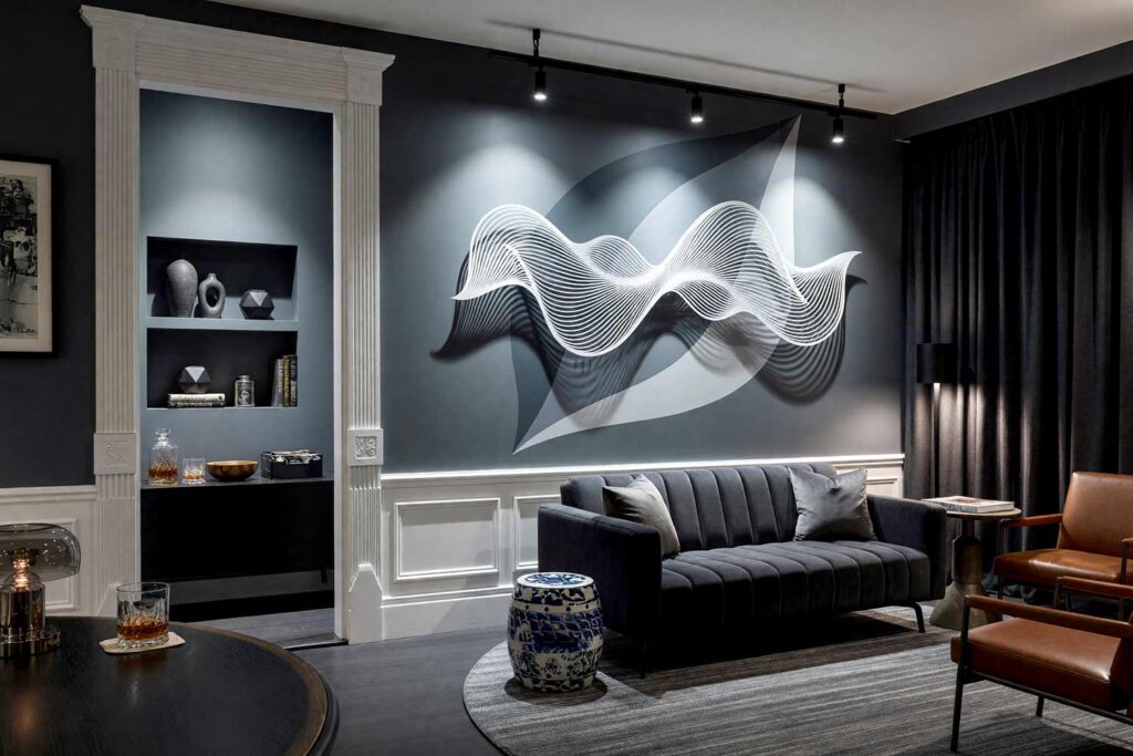 Modern Lounge with Gray Walls and Gray Accent Mural and Wall Sculpture-5, cinematic modern lounge storm gray walls deep slate gray leaf panels painting for wall sculptures cloud white trim dark gray floor. A luxurious Hollywood-inspired screening room in a Scottsdale neighborhood featuring a silver-white contour wave sculpture mounted against overlapping tonal gray painted leaf panels. Outfitted with a cognac leather lounge chair, round striped rug, small round side table, and dark gray flooring, this atmospheric space provides dramatic, high-end comfort. painting for wall sculptures, metal wall art paint ideas, paint backdrop for metal wall hanging, extending wall art with paint, painting behind wall sculptures, paint ideas for metal wall art, wall color for metal wall sculptures, accent wall paint for metal art